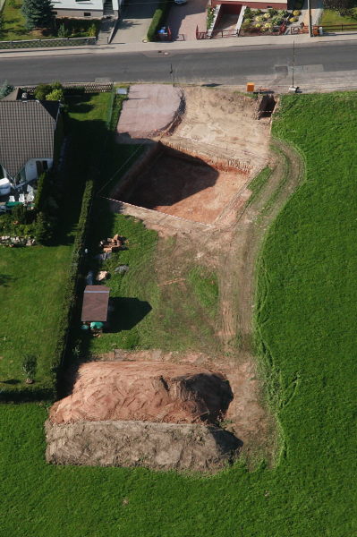 An aerial view of the lot with the building pit
